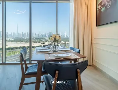 a dining room with a table and a large window at Manzil - 1BR Apartment in Farhad Aziz Residence with Burj View in Dubai