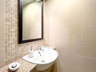 a bathroom with a white sink and a mirror at Stunning 2 bedrooms in Sky Gardens DIFC in Dubai
