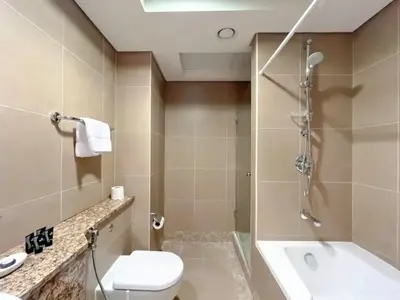 a bathroom with a shower and a toilet and a sink at Stunning 2 bedrooms in Sky Gardens DIFC in Dubai