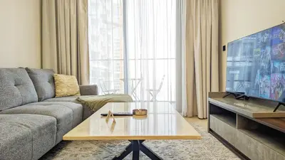 a living room with a couch and a coffee table at Modern Luxury Fully Furnished 1BH Apartment in Binghatt Heights JVC - Easy Access to JBR, Circle Mall & Dubai Hills Mall in Dubai