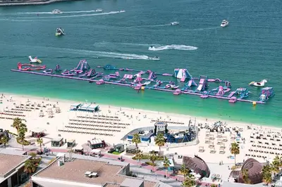 an aerial view of a beach with a water park at 2 min walk to JBR Beach & Dubai Marina - Sea View in Dubai
