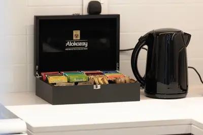 a black box filled with packets next to a tea kettle at 2Bed-400m from Burj Khalifa- Heart of Dubai in Dubai