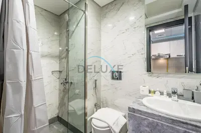 a bathroom with a glass shower and a sink at Charming 2BR at MAG 515 Dubai South by Deluxe Holiday Homes in Dubai