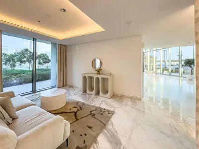 a living room with a white couch and a large window at Brand New! Dubai Eye & JBR Beach Panorama! in Dubai
