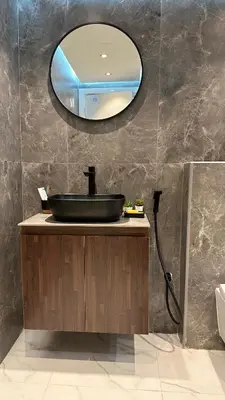 a bathroom with a black sink and a mirror at Lavender 2 jvc in Dubai
