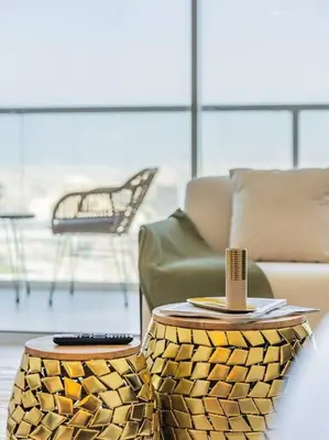 a living room with a couch and two tables at Elegant One Bed Apartment - Hameni Tower,JVC in Dubai