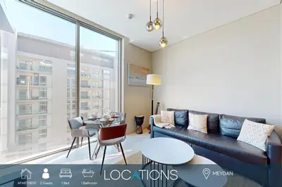 a living room with a couch and a table at Locations I Creek Vistas Reserve I Luxury Calm 1BR I 12 Min Drive to Downtown Dubai & Business Bay I Modern Comfort in Meydan Community in Dubai