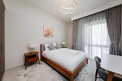 a bedroom with a large bed and a window at Vida Creek Beach 1 Bedroom in Dubai