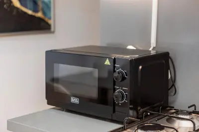 a microwave oven sitting on top of a counter at Studio Sterling BusinessBay in Dubai