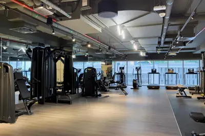 a gym with lots of treadmills and exercise equipment at Studio Sterling BusinessBay in Dubai