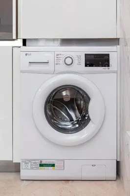 a white washing machine sitting in a kitchen at Studio Sterling BusinessBay in Dubai