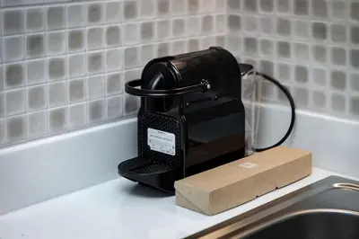 a black iron sitting on a counter next to a sink at Modern Studio in Seven Palm in Dubai