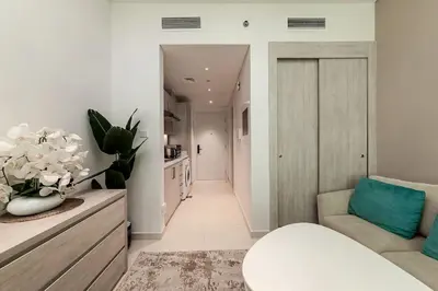 a living room with a couch and a chair at Modern Studio in Seven Palm in Dubai