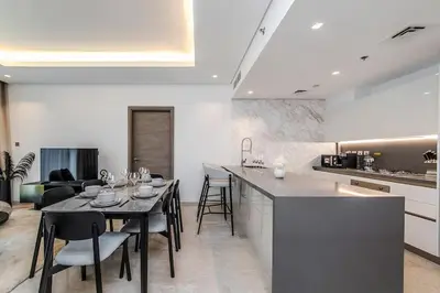 a kitchen and dining room with a table and chairs at Burj Khalifa View 3bedroom in Dubai