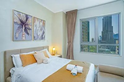 a bedroom with a bed and a large window at Savis Homes - Luxury 2 Bedroom Suite with Full Burj Khalifa View in Dubai