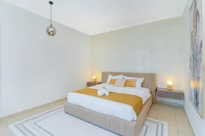 a bedroom with a bed with a teddy bear on it at Savis Homes - Luxury 2 Bedroom Suite with Full Burj Khalifa View in Dubai