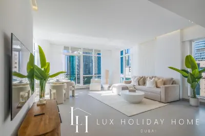 a living room with a couch and a table at LUX The Majara Marina View Suite in Dubai