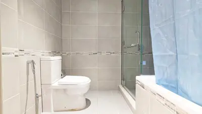 a bathroom with a toilet and a shower at Fully Furnished 1BR In Montrose Tower B Dubai, Close by Dubai Science Park, Dubai Miracle Garden, Dubai Hills Mall in Dubai