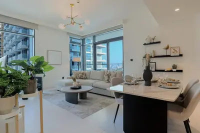 a living room with a couch and a table at HiGuests - Elegant 2-Bedroom Retreat at Marina Vista 2 in Dubai