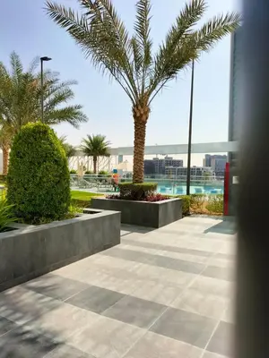 a palm tree in the middle of a sidewalk at Elegant Studio Stay near Miracle Garden, Butterfly Garden & Dubai Hills Mall in Dubai