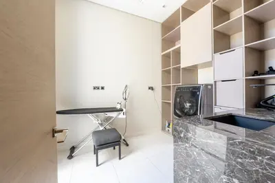 a kitchen with a desk and a chair in a room at Ultra-Luxury 6BR Palm Villa - Private Pool & Beach in Dubai
