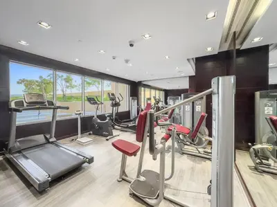 a gym with several treadmills and cardio machines at FIRST CLASS Studio Luxury Getaway in Dubai