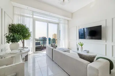 a living room with a couch and a table at Daniels Stylish 1BR at Silverene Tower Dubai Marina in Dubai
