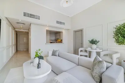 a living room with a couch and a table at Daniels Stylish 1BR at Silverene Tower Dubai Marina in Dubai