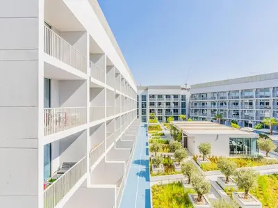an image of an apartment building with a courtyard at Modern Spacious- 2 BR with Pool & Gym- Luma 22 JVC in Dubai