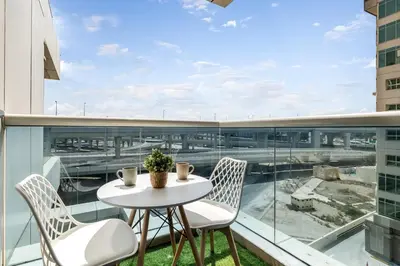 a white table and chairs on a balcony with a view at Spacious 3 BR Newly Furnished - Dubai Marina in Dubai