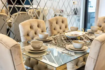 a dining room with a glass table and chairs at Royal King Size Stay 2BR With Marina View in Dubai