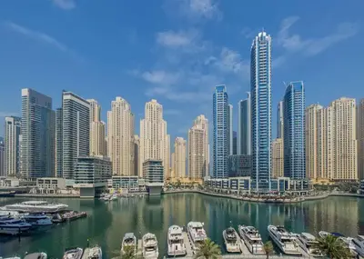 a view of a city with boats in a harbor at Royal King Size Stay 2BR With Marina View in Dubai