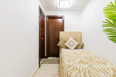 a bedroom with a bed and a wooden door at Luxury 3BR with Stunning Full Marina View in Dubai in Dubai