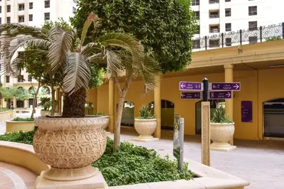 a large vase with a palm tree in front of a building at GuestReady - Serene retreat with Ain Dubai Views in Dubai