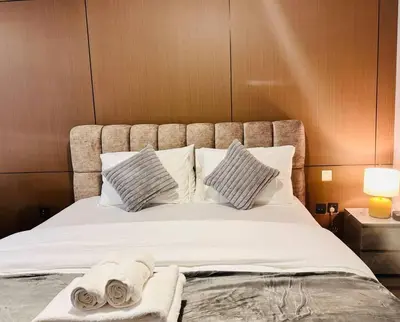 a bedroom with a bed with towels on it at Airvistas CityNest Retreat at Business Bay, Dubai in Dubai