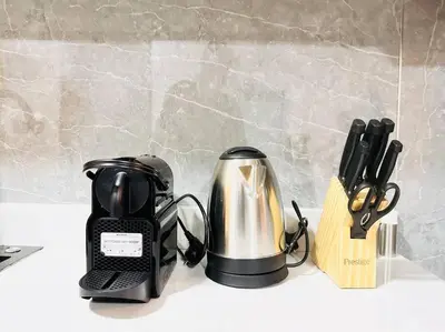a coffee maker and a tea kettle on a counter at Airvistas CityNest Retreat at Business Bay, Dubai in Dubai