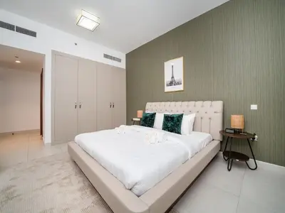 a bedroom with a large white bed in a room at Chic 1 Bed Getaway in Al Jaddaf Easy City Access in Dubai