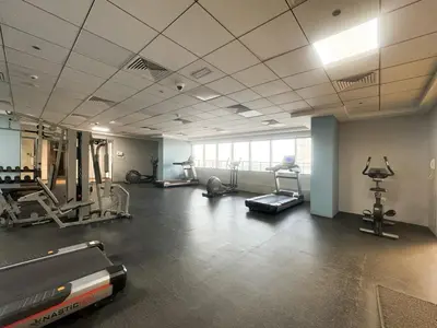 a gym with treadmills and machines in a room at Chic 1 Bed Getaway in Al Jaddaf Easy City Access in Dubai
