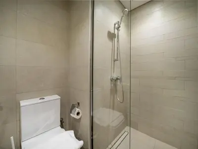 a bathroom with a glass shower with a toilet at Elegant Studio in Azizi Riviera, Meydan in Dubai