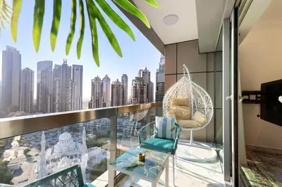 a room with a hammock on a balcony with a city skyline at Lux apartments x Dubai studio 22 in Dubai
