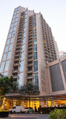 a large building with cars parked in front of it at Modern Apartment near Burj khalifa in Dubai