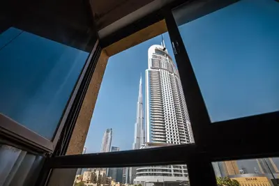 a view of a tall building from a window at Elegant 2BR Apartment in Yansoon 3 with Burj Khalifa Views in Dubai