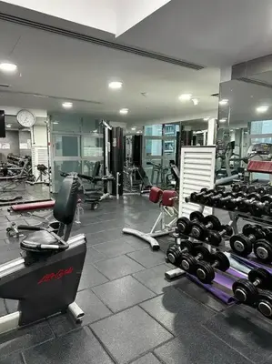 a gym with a bunch of equipment in a room at Stunning Newly Furnished Apartment Dubai Marina in Dubai