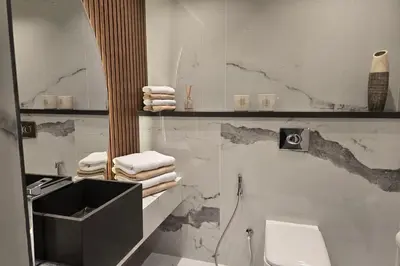 a bathroom with a sink and a toilet and a tub at Beachfront 250 view private beach high floor in Dubai