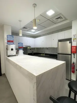 a large kitchen with a large white counter top at Capsule Hostel Room in Business Bay Near Downtown in Dubai