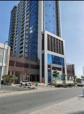 a tall building with a car parked in front of it at Capsule Hostel Room in Business Bay Near Downtown in Dubai