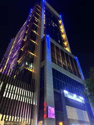 a tall building with blue lights on top of it at Capsule Hostel Room in Business Bay Near Downtown in Dubai