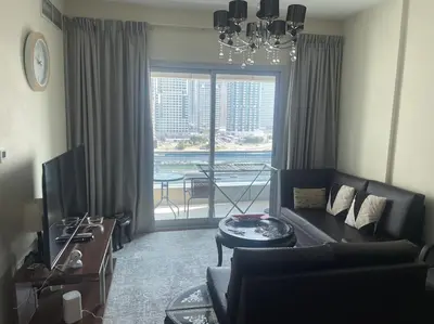 a living room with a couch and a large window at Marina, Beach & Mall Walking Dis in Dubai