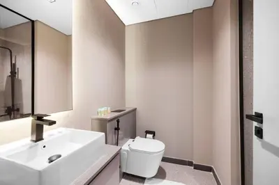 a bathroom with a white sink and a toilet at Sukoon's Elegant Suite 2 in Dubai
