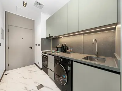 a kitchen with a sink and a dishwasher at Sukoon's Elegant Suite 2 in Dubai